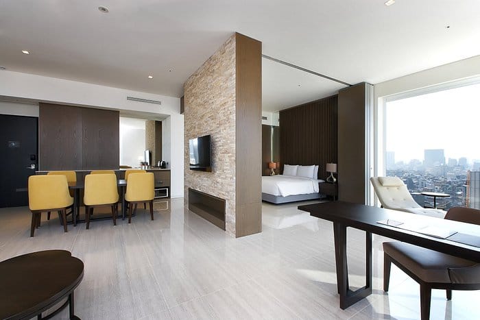 Modern hotel suite with large windows, ideal for corporate retreats and meetings.