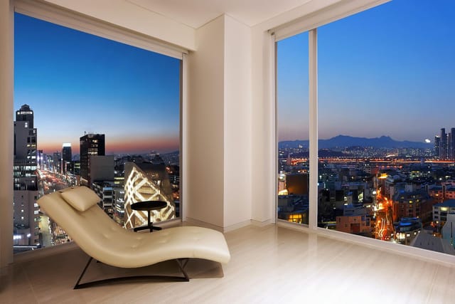 Modern hotel suite with cityscape view, perfect for events and gatherings.