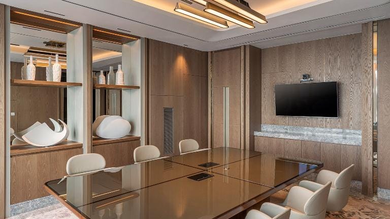 Modern meeting room with sleek table, ideal for corporate events and gatherings.
