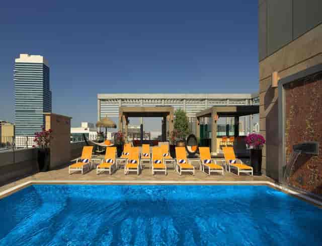 Rooftop pool at Senso Terrace, Radisson Blu Dubai for upscale events and networking.