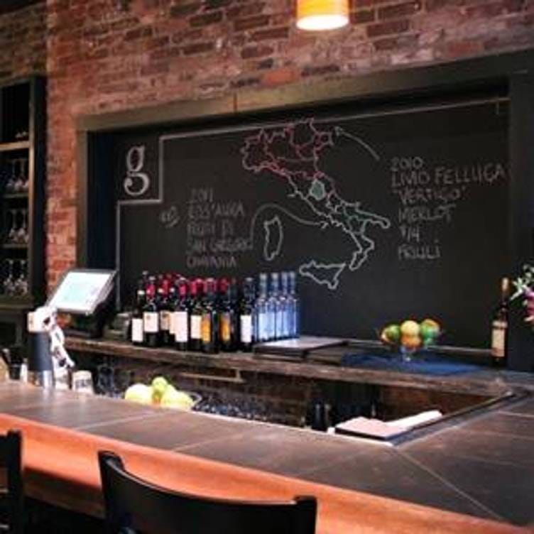Stylish bar at Giulia Restaurant with Italian wine map, ideal for wine tastings and events.