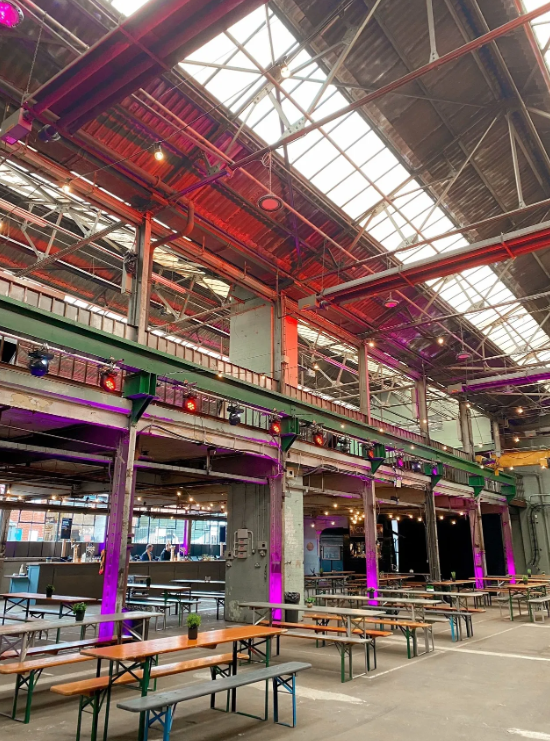 Spacious industrial venue with high ceilings for events and gatherings in The Steamworks. - Banner