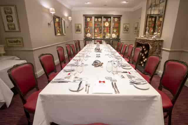 Elegant banquet table in Lanson Library, fine china, perfect for formal events.