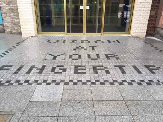 Library Meeting Room entrance with "Wisdom at Your Fingertip" tiles for events and meetings.