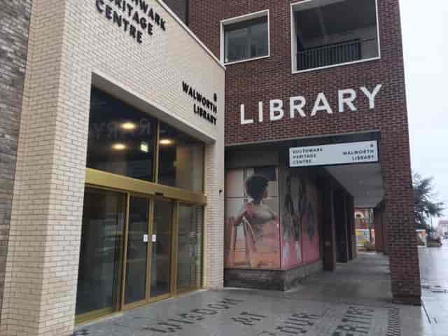 Modern library entrance with glass door at Southwark Heritage Centre for events and workshops.