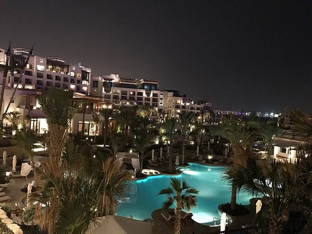 Luxurious Jumeirah Al Naseem meeting room with illuminated pool, ideal for upscale events.