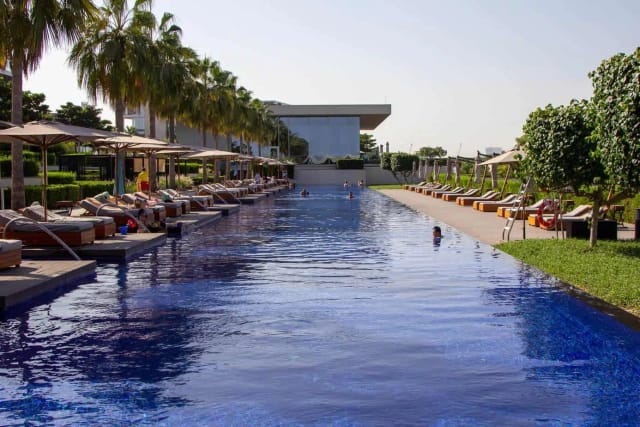 Luxurious beachfront poolside at Oberoi Al Zorah, ideal for upscale events and gatherings.