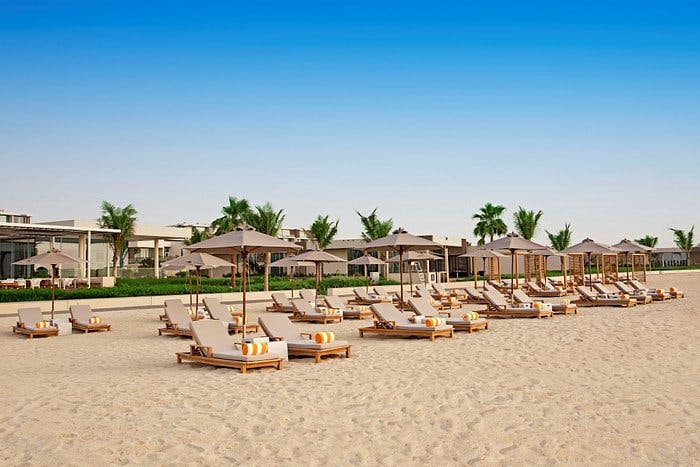 Beachfront at Oberoi Al Zorah Ajman with lounge chairs, perfect for networking events.