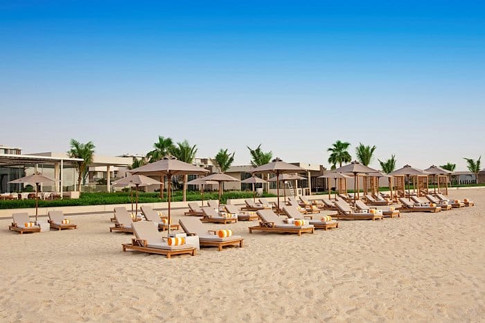 Beachfront at Oberoi Al Zorah Ajman with lounge chairs, perfect for networking events.