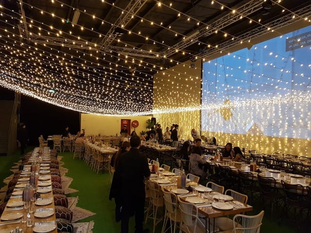 Elegant event space in Warehouse Four with twinkling lights for sophisticated dinners.