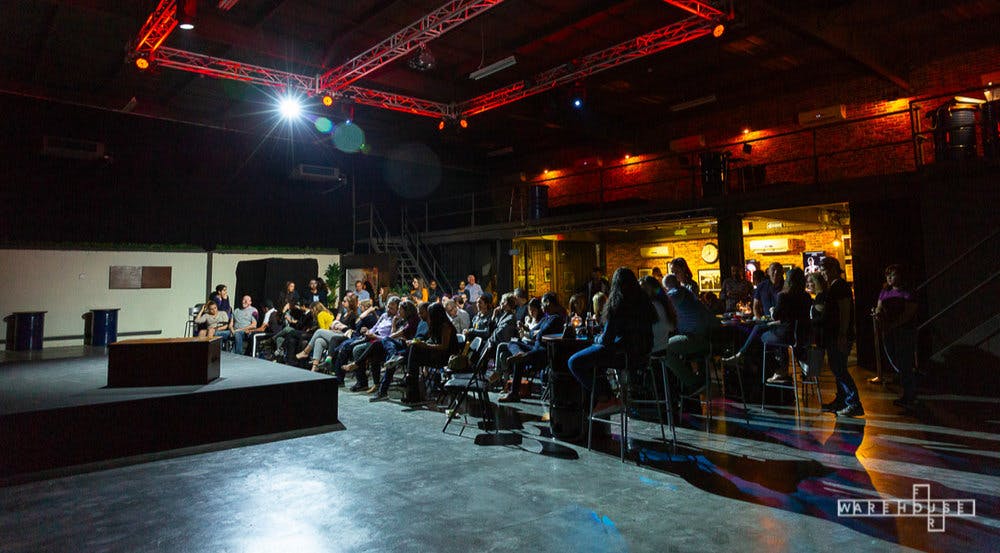 Event space in Warehouse Four with engaged audience, ideal for networking and presentations.