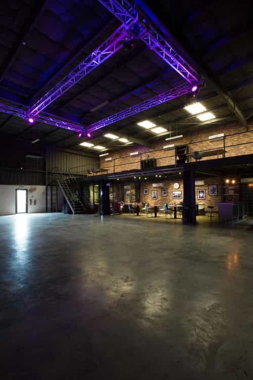 Versatile industrial event space with exposed brick, ideal for corporate meetings and social gatherings.