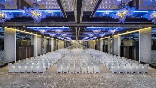 Elegant Creek Ballroom in Dubai with white chairs for conferences and seminars.
