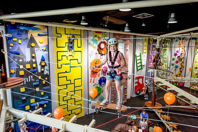 Private party area with colorful climbing walls at IMG Worlds of Adventure for team-building events.