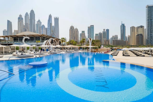 Upscale poolside venue with skyscrapers, perfect for networking events and gatherings.
