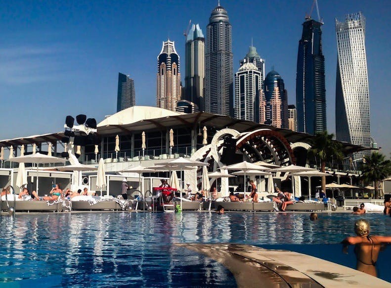 Vibrant poolside garden venue with skyline, perfect for upscale events and gatherings.