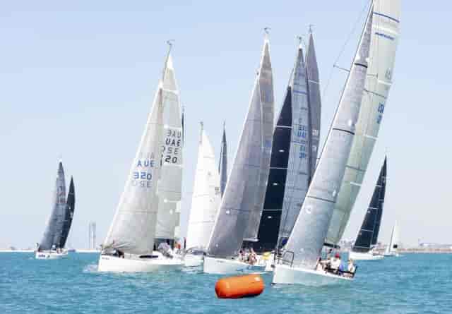 Vibrant sailing regatta at Dubai Offshore Sailing Club for corporate team-building events.