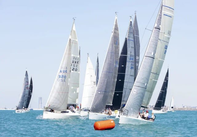 Vibrant sailing regatta at Dubai Offshore Sailing Club for corporate team-building events.