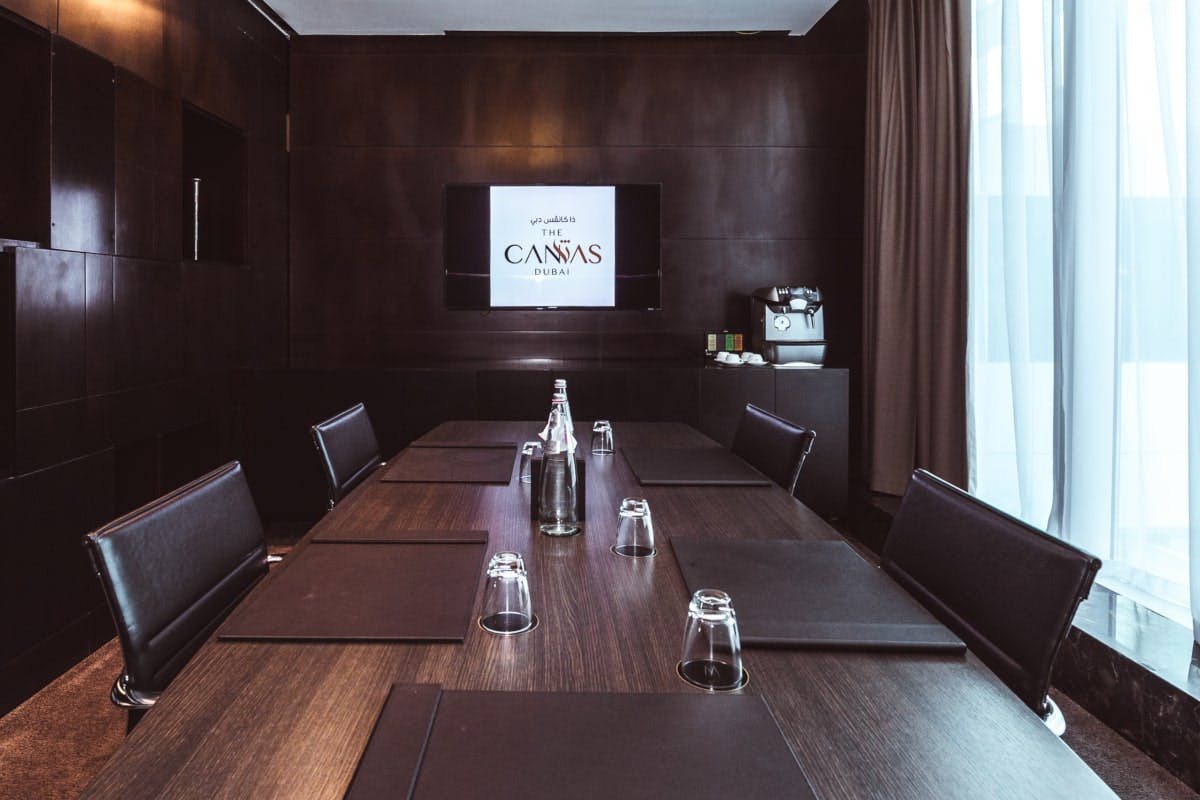 Modern meeting room with dark wood finishes, ideal for professional gatherings and presentations.