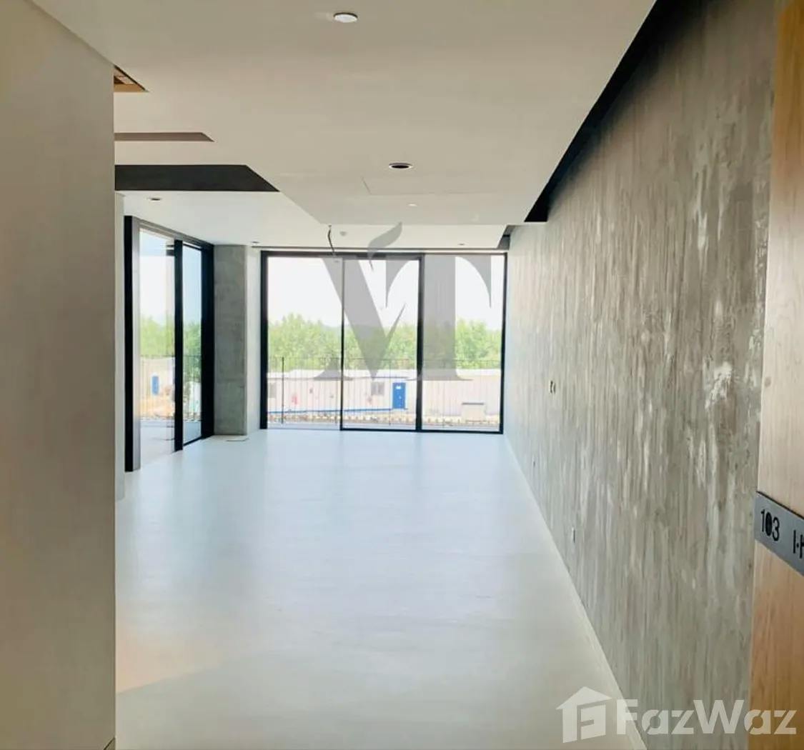 Modern minimalist event space with large windows, ideal for corporate meetings and workshops.