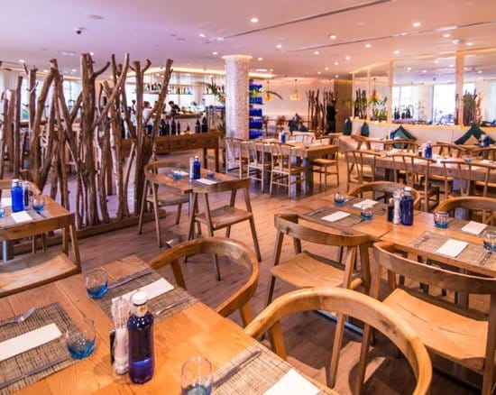 Modern restaurant in Riva Beach with wooden decor, perfect for gatherings and events.