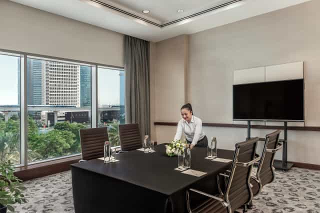 Meeting room at The H Dubai with sleek table, ideal for corporate events and presentations.