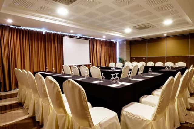 Molave Grand Ballroom setup for professional meetings with elegant chairs and projector.
