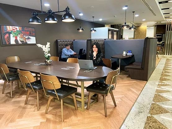 Modern breakout room with large table, ideal for networking events and meetings.