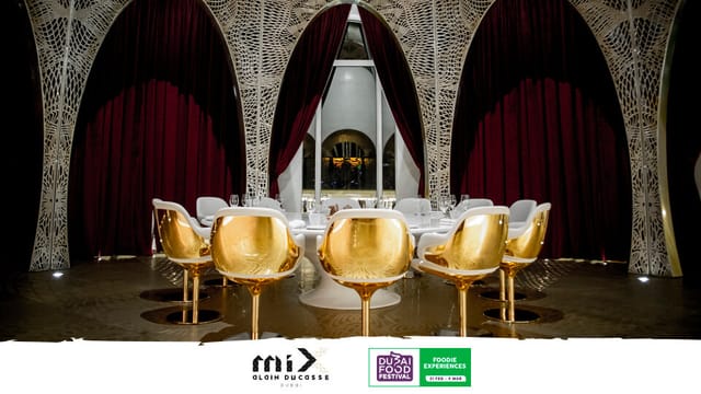 Elegant restaurant event space with golden chairs and red drapery for corporate gatherings.