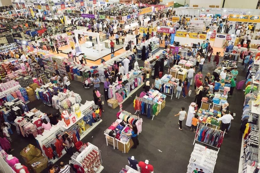 Expo Centre Sharjah exhibition hall with vendor booths at a bustling trade show.