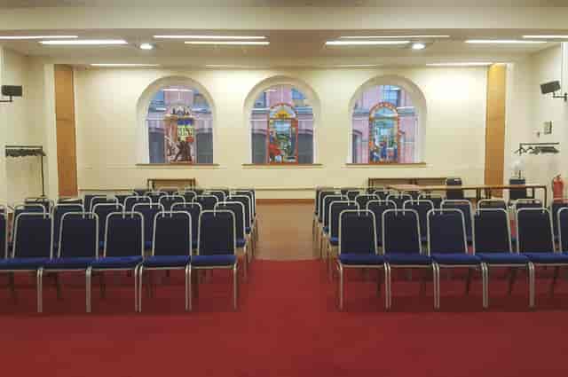 Large Hall at Mechanics Conference Centre with blue chairs for meetings and workshops.