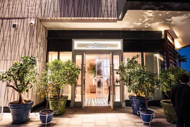 Elegant restaurant entrance in Alici with potted trees, perfect for upscale events.