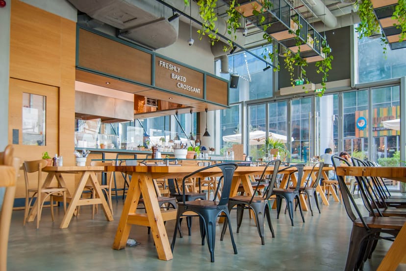 Modern café with natural light, perfect for casual meetings and networking events.