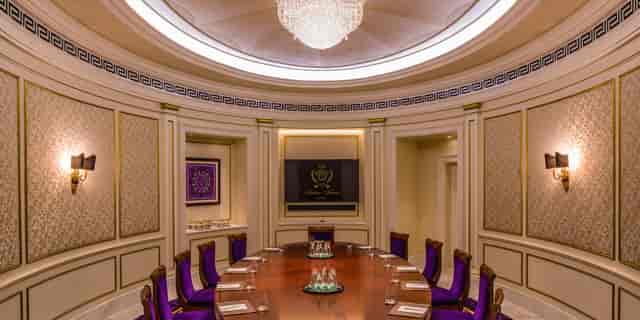 Luxurious boardroom with round table and purple chairs at Palazzo Versace Dubai.