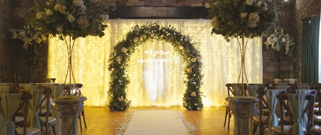 Elegant floral arch in Park Hall Hotel's Dining Hall, ideal for weddings and celebrations.