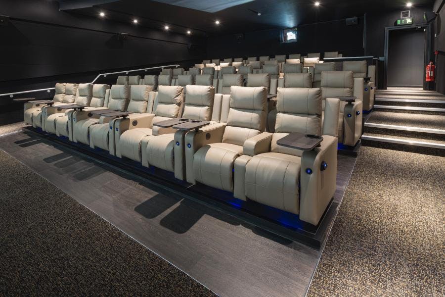 Upscale ODEON LUXE Swiss Cottage cinema with plush recliners for private screenings.