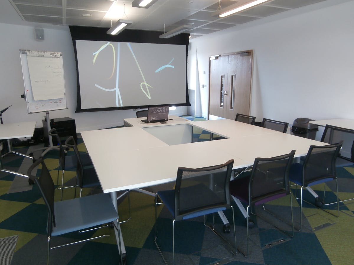 Modern Meeting Room 6 at Canada Water Library with large table, ideal for workshops.