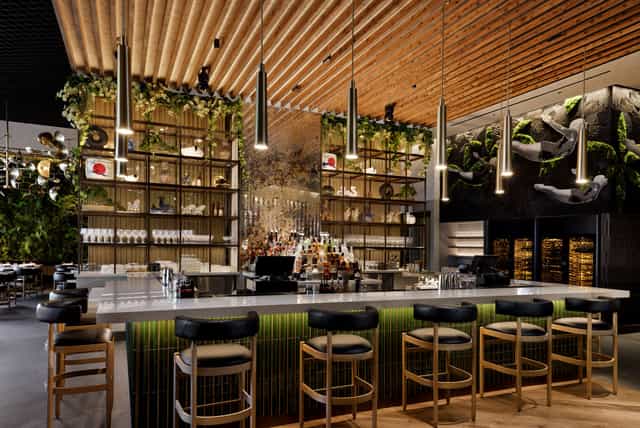 Modern bar area in KYU, ideal for networking events and cocktail receptions.