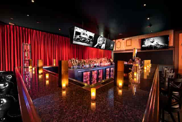 Stylish 1923 Prohibition Bar with red curtains, ideal for networking events and gatherings.