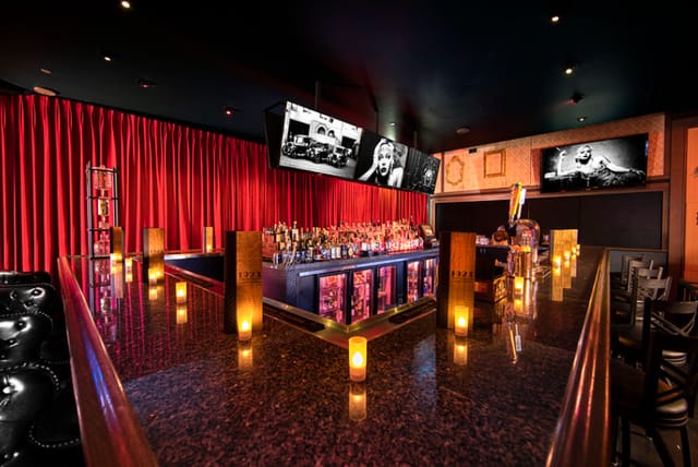 Stylish 1923 Prohibition Bar with red curtains, ideal for networking events and gatherings.