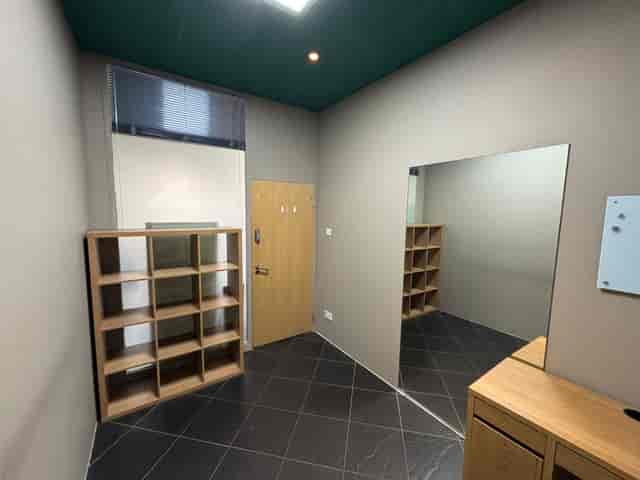 Minimalist personal office space with large mirror for meetings and events at The Factory Fitness.