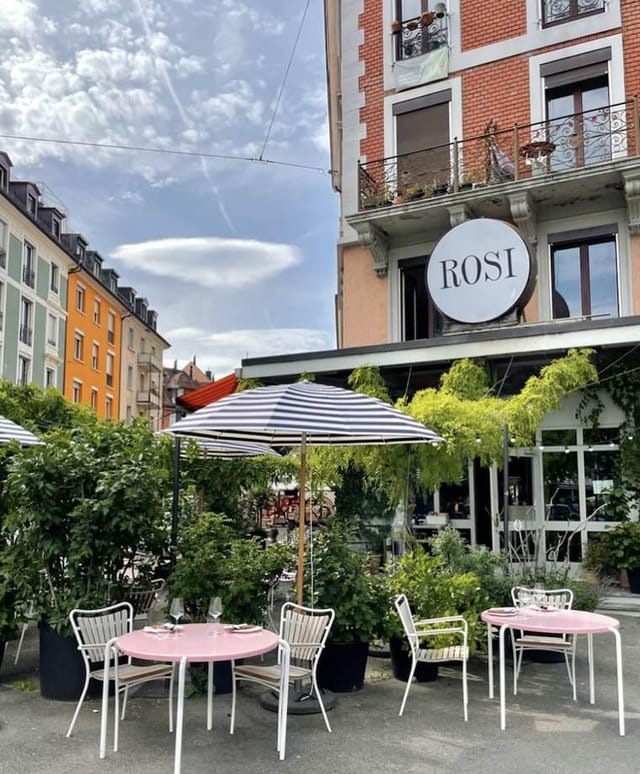Charming outdoor venue at ROSI Restaurant with striped umbrellas for casual events.