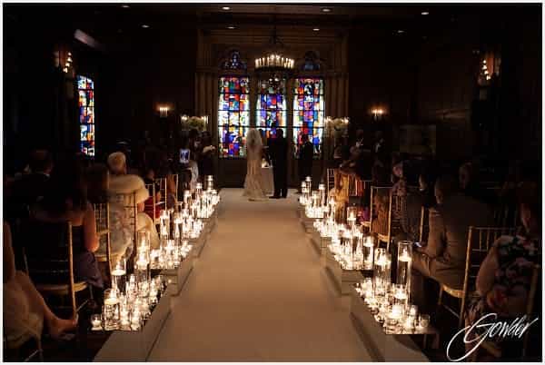 Elegant wedding ceremony at King Arthur Court, InterContinental Chicago, with candlelit aisle.