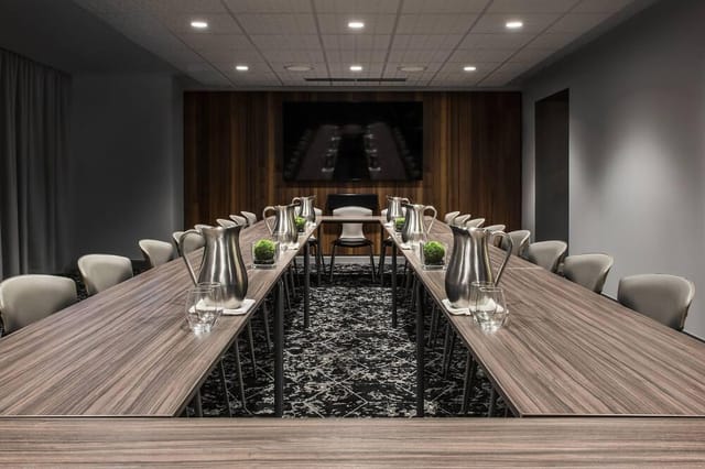 Modern meeting room in Virgin Hotels Chicago, featuring a sleek table for corporate events.