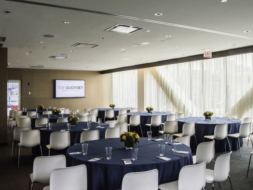 Truss Meeting Room at The Godfrey Hotel Chicago, ideal for corporate events with round tables.