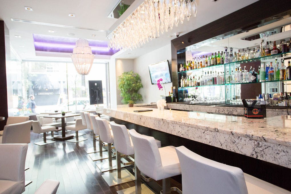 Sleek bar area at Divine Lounge, Ivy Hotel for networking events and gatherings.