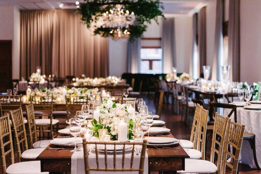 Elegant banquet hall at Ivy Hotel with floral centerpieces, ideal for weddings and events.