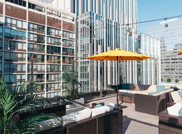 Sky Terrace at Ivy Hotel with yellow umbrellas, perfect for outdoor events and gatherings.