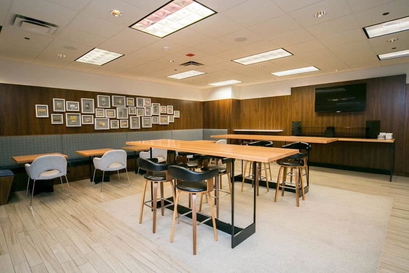 Double Cross Lounge at Kinzie Hotel: modern meeting space with warm wood accents for networking.