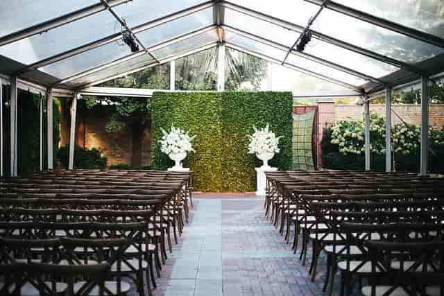 Outdoor wedding event space with clear tent and floral arrangements in Chicago.